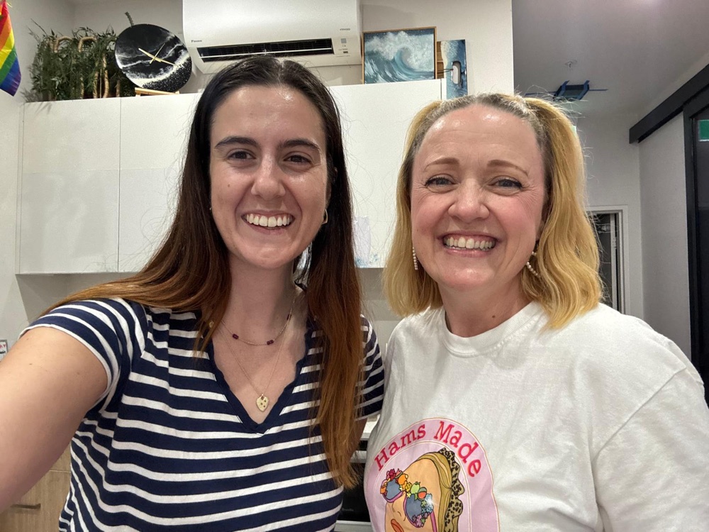 Lucy and a student smiling together in the studio